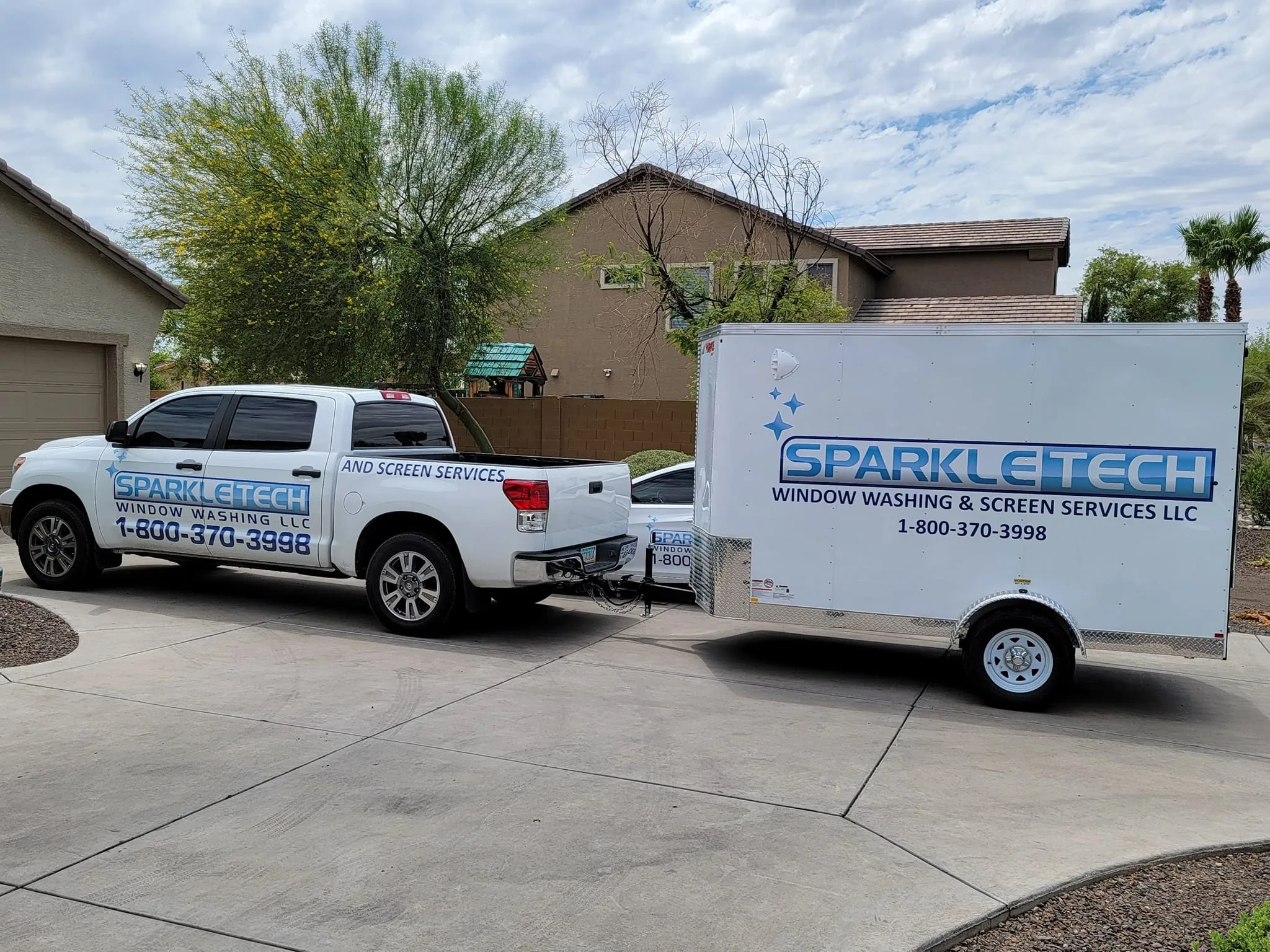 White pickup truck and enclosed trailer branded with Sparkle Tech Window Washing and Screen Services parked in a residential